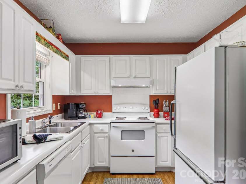 169 Highview Drive, Maggie Valley, NC 28751.  MLS# CAR4411083, YatesRealty ID 50102. Whtie cabinets with window overlooking yard