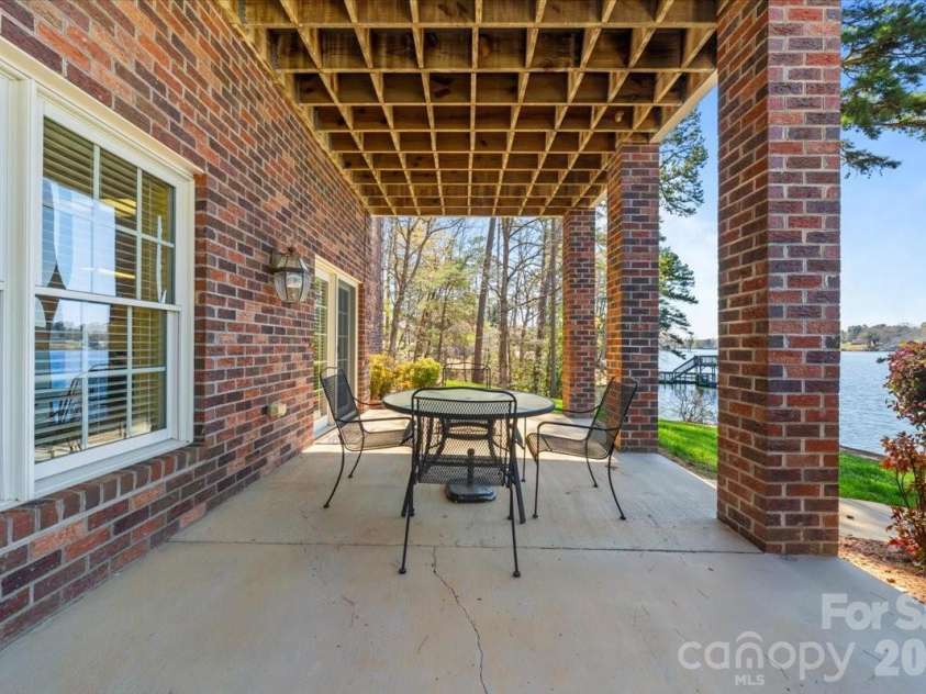 704 Shoreline Drive, New London, NC 28127.  MLS# CAR4361160, YatesRealty ID 50128. Lower level walkout patio