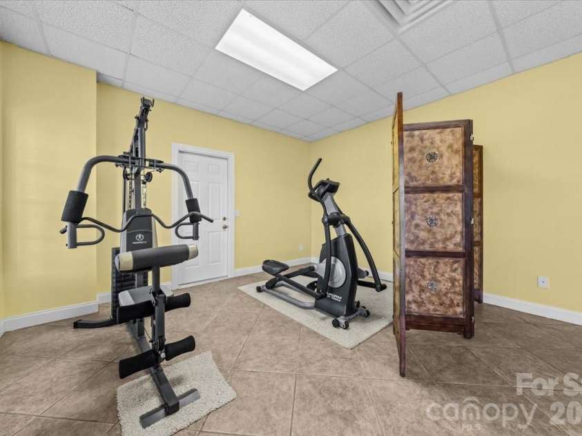 704 Shoreline Drive, New London, NC 28127.  MLS# CAR4361160, YatesRealty ID 50128. Lower level workout space