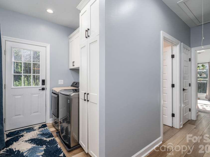 1551 Brevard Place Road, Iron Station, NC 28080.  MLS# CAR4422440, YatesRealty ID 50132. Convenient main-level laundry area with built-in storage and direct access to the side entrance.