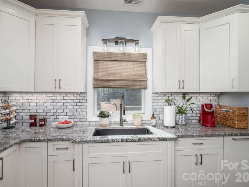 1551 Brevard Place Road, Iron Station, NC 28080.  MLS# CAR4422440, YatesRealty ID 50132. Kitchen sink is a quart-composite under-mount sink overlooking the backyard.