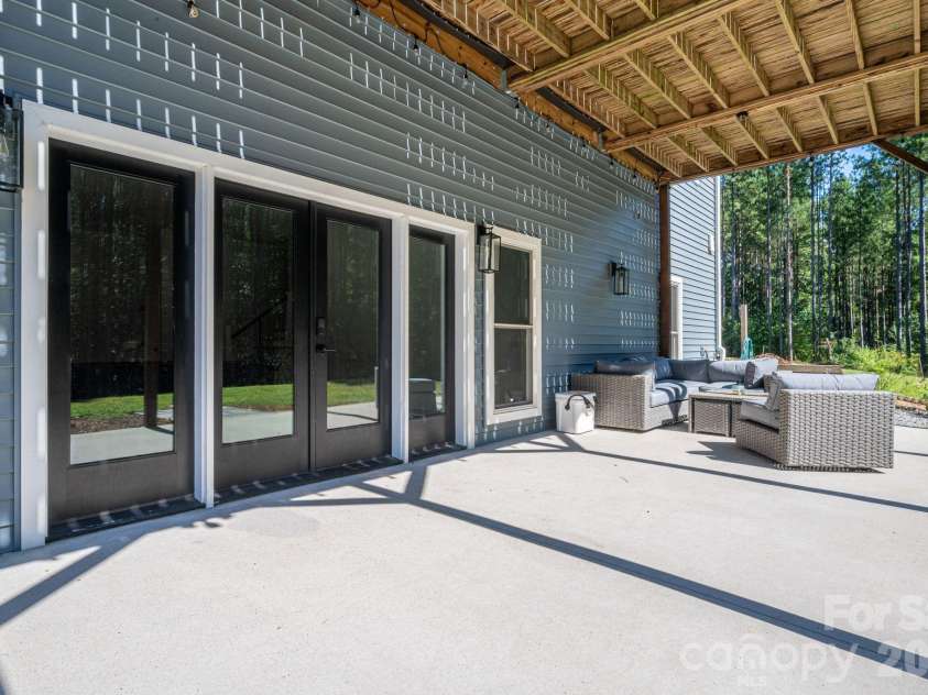 1551 Brevard Place Road, Iron Station, NC 28080.  MLS# CAR4422440, YatesRealty ID 50132. Spacious covered lower-level patio with direct access to the finished basement.