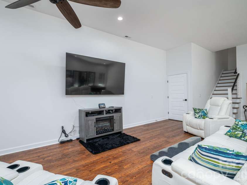 1551 Brevard Place Road, Iron Station, NC 28080.  MLS# CAR4422440, YatesRealty ID 50132. The finished walkout basement offers exceptional flexibility for multigenerational living, guests, or extended stay, with a bedroom, full bath, flex room, spacious living area, and direct access to the covered p