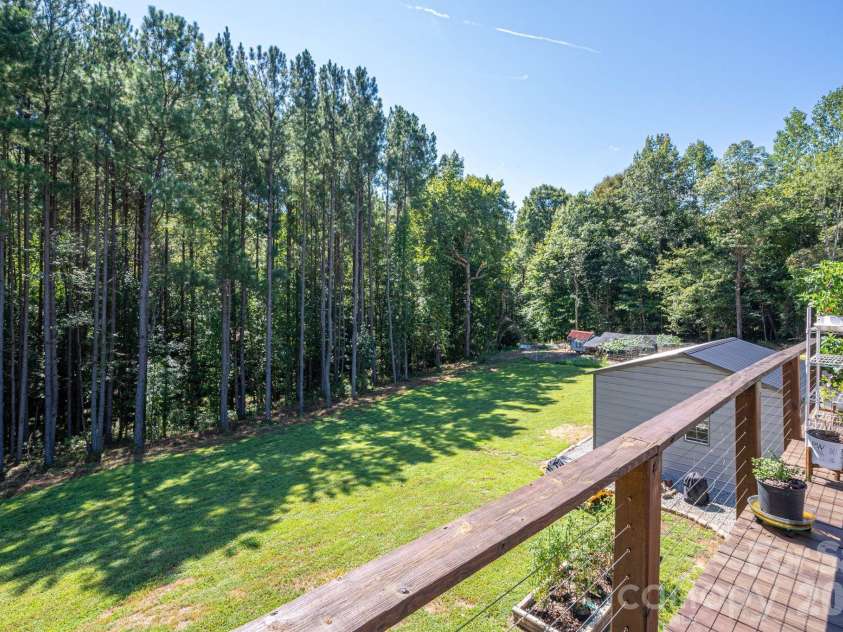 1551 Brevard Place Road, Iron Station, NC 28080.  MLS# CAR4422440, YatesRealty ID 50132. View from the upper deck overlooking the spacious backyard and wooded acerage.