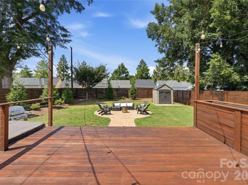 700 Woodruff Place, Charlotte, NC 28208.  MLS# CAR4422383, YatesRealty ID 50152. Expansive back deck with built-in planter beds overlooking flat and landscaped yard