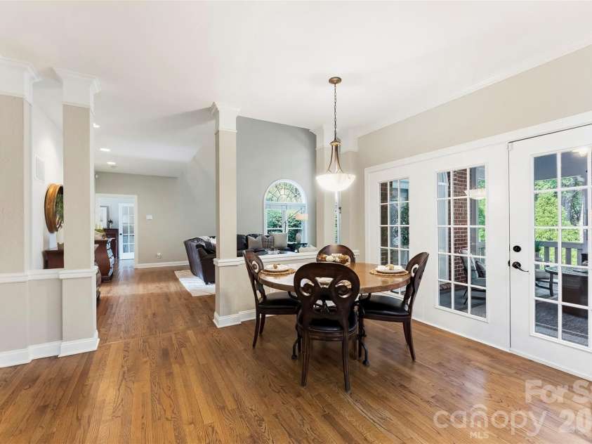 7337 Versailles Lane, Charlotte, NC 28277.  MLS# CAR4418758, YatesRealty ID 50195. Multiple windows and French doors bring the peaceful backyard setting into this cheerful everyday dining space