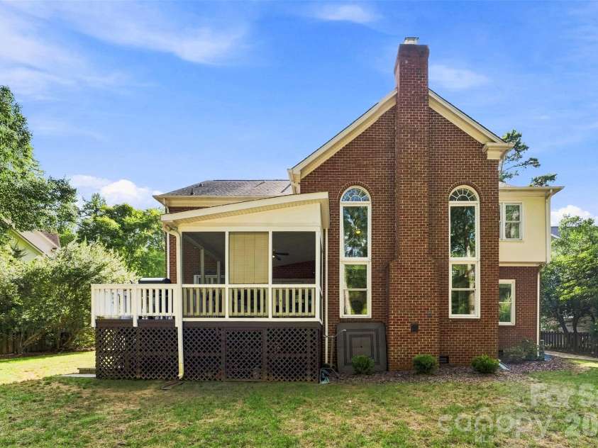 7337 Versailles Lane, Charlotte, NC 28277.  MLS# CAR4418758, YatesRealty ID 50195. The striking rear elevation showcases classic brickwork and soaring arched windows that flood the great room with natural light