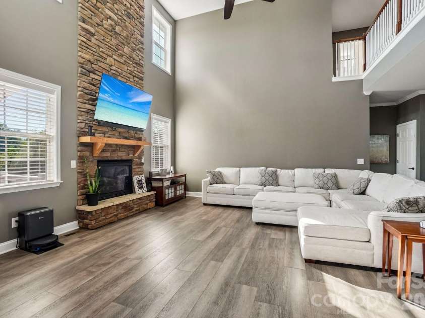 19 Glen Coe Drive, Fletcher, NC 28732.  MLS# CAR4418836, YatesRealty ID 50196. Open enough to gather, cozy enough to unwind - this room does both effortlessly with a floor to ceiling stone fireplace feature.