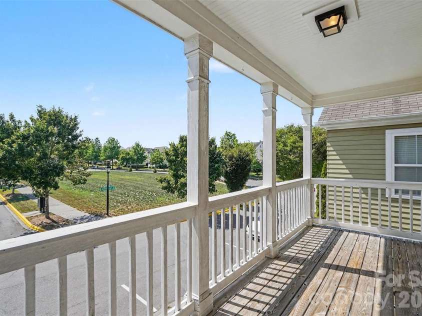13913 Helen Benson Boulevard, Davidson, NC 28036.  MLS# CAR4418456, YatesRealty ID 50201. An upper covered front porch off the Primary overlooking a common area.