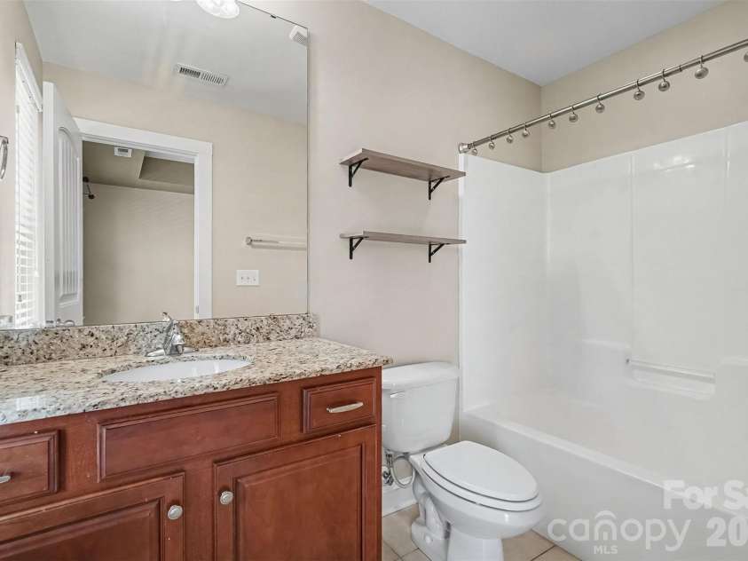 13913 Helen Benson Boulevard, Davidson, NC 28036.  MLS# CAR4418456, YatesRealty ID 50201. Bathroom that adjoins both secondary bedrooms with granite countertops