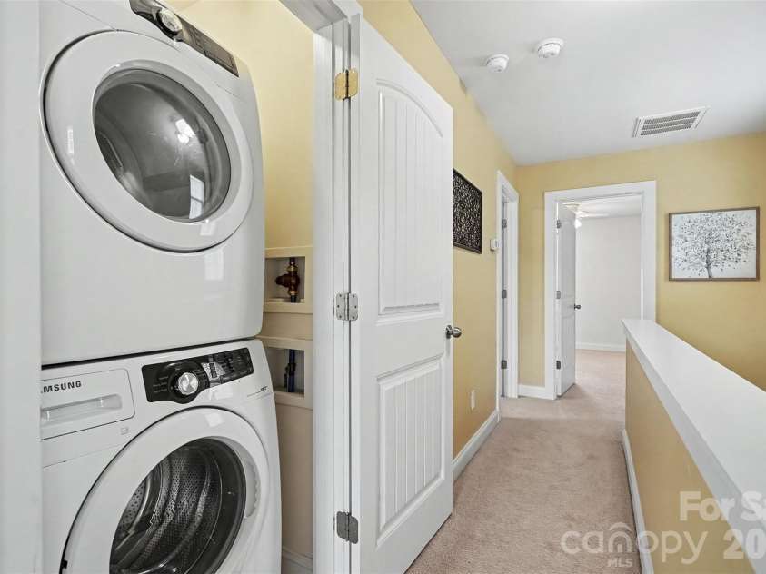 13913 Helen Benson Boulevard, Davidson, NC 28036.  MLS# CAR4418456, YatesRealty ID 50201. Hall laundry closet - stackable washer and dryer convey