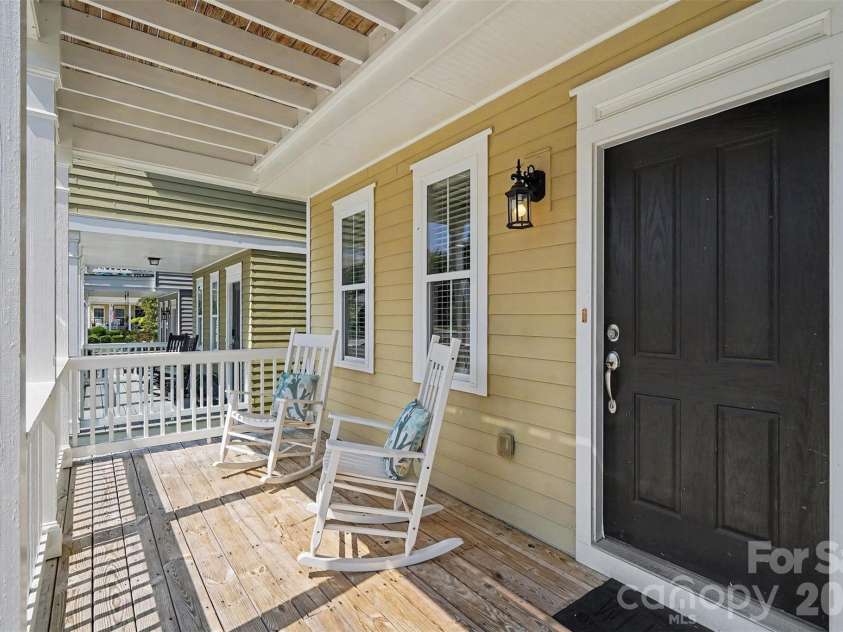 13913 Helen Benson Boulevard, Davidson, NC 28036.  MLS# CAR4418456, YatesRealty ID 50201. Inviting rocking chair front porch