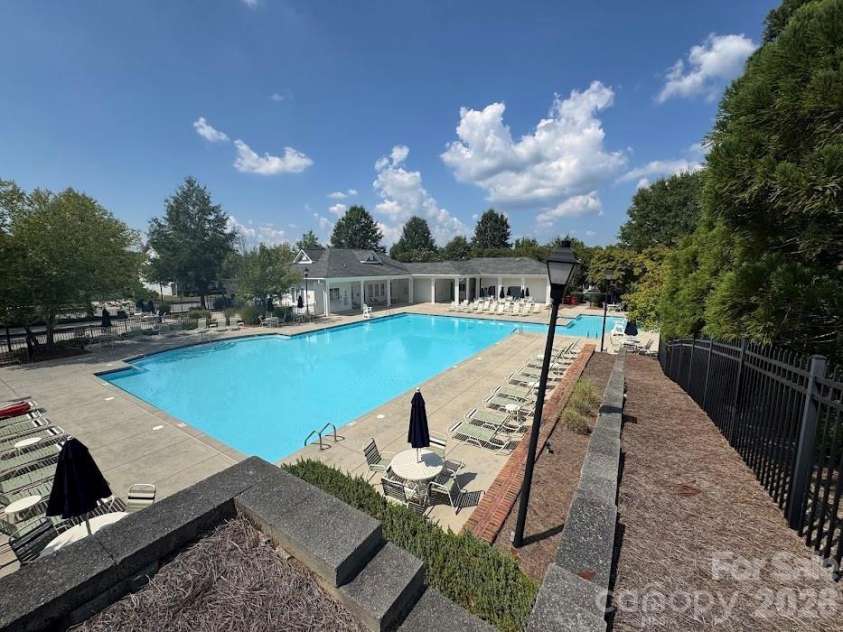 13913 Helen Benson Boulevard, Davidson, NC 28036.  MLS# CAR4418456, YatesRealty ID 50201. There is a lap pool, a kid splash pool and another swimming area.
