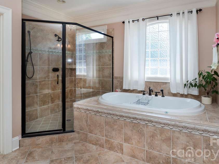 7786 Chapel Creek Drive, Denver, NC 28037.  MLS# CAR4407968, YatesRealty ID 50207. Primary bath soaking tub and shower...