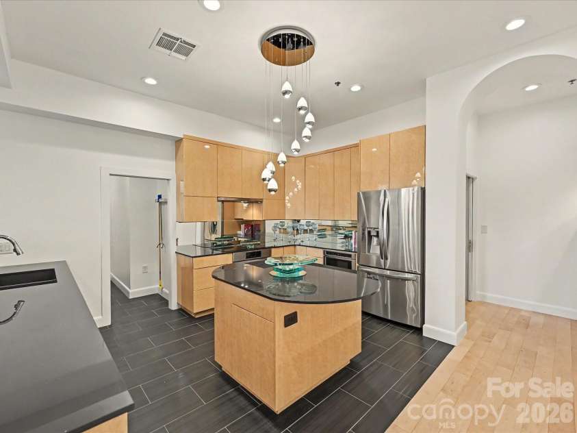 127 Tryon Street, Charlotte, NC 28202.  MLS# CAR4388173, YatesRealty ID 5025. Kitchen looking into left laundry/ Rt back entrance into Study