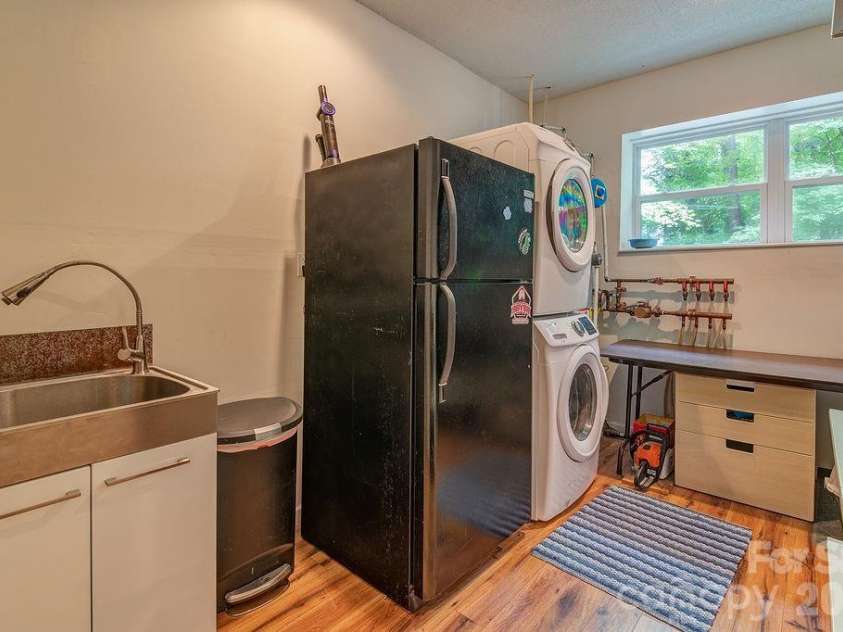 11 Muirfield Court, Arden, NC 28704.  MLS# CAR4422078, YatesRealty ID 50256. Laundry and utility area on lower level is functional and efficient