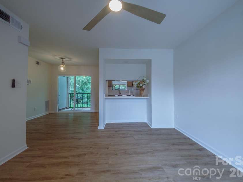 11022 Running Ridge Road, Charlotte, NC 28226.  MLS# CAR4422317, YatesRealty ID 50264. Living Room, Dining and kitchen