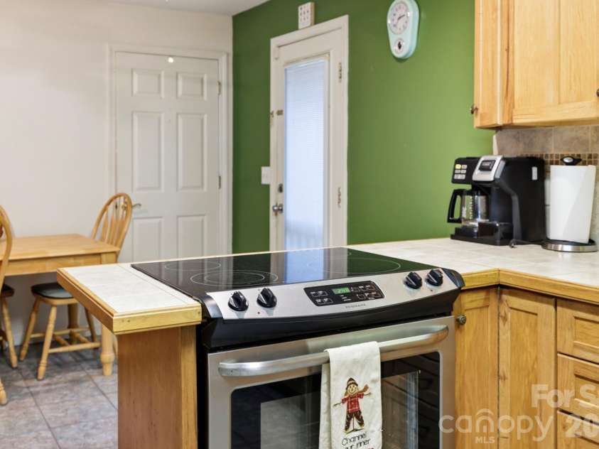 10687 Cruso Road, Canton, NC 28716.  MLS# CAR4423169, YatesRealty ID 50320. Cooktop, dining area, back door