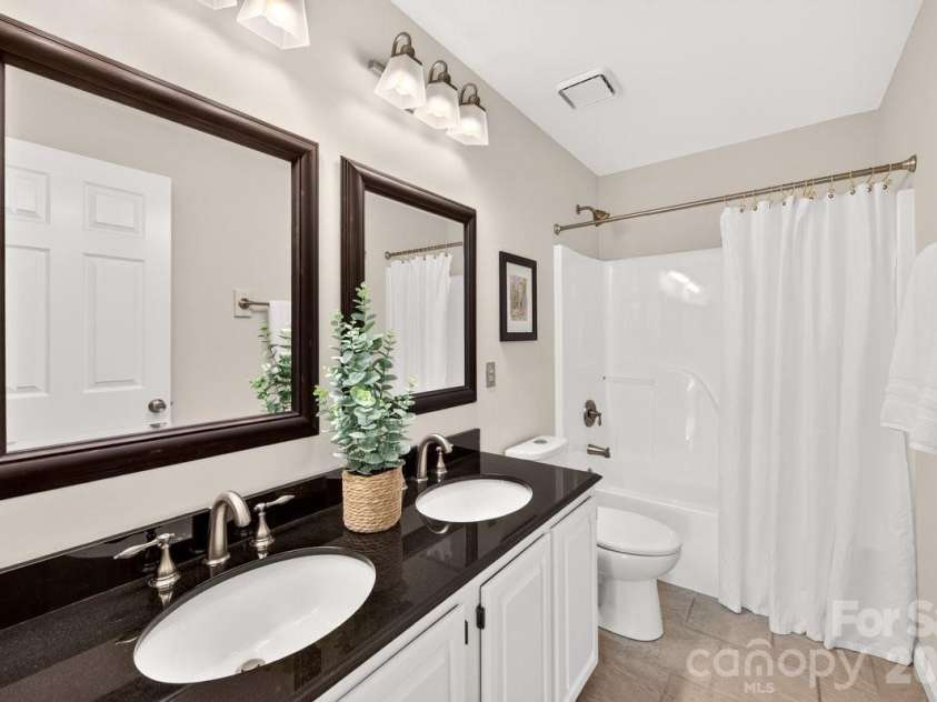 2901 Firewood Drive, Matthews, NC 28105.  MLS# CAR4422763, YatesRealty ID 50324. Hall Bath with dual vanities.