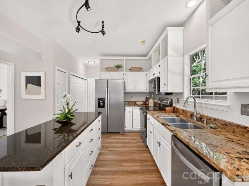 2901 Firewood Drive, Matthews, NC 28105.  MLS# CAR4422763, YatesRealty ID 50324. The kitchen features an island with wonderful extra storage space.