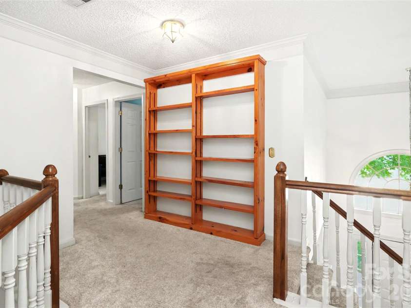 7903 Long Nook Lane, Charlotte, NC 28277.  MLS# CAR4414616, YatesRealty ID 50326. Extra storage in book case in hall