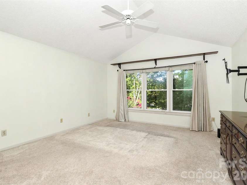 7903 Long Nook Lane, Charlotte, NC 28277.  MLS# CAR4414616, YatesRealty ID 50326. Primary suite has bedroom with 3 windows, high ceiling, ceiling fan and neutral carpet