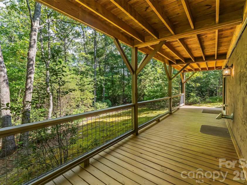 85 Trellis Drive, Nebo, NC 28761.  MLS# CAR4422991, YatesRealty ID 50327. Lower back covered porch