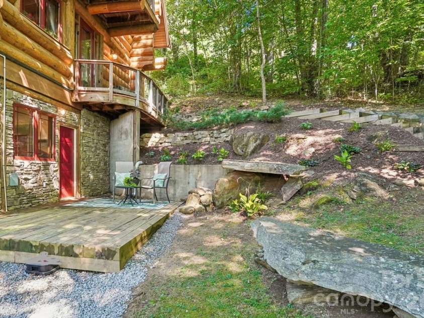 476 Waterford Drive, Maggie Valley, NC 28751.  MLS# CAR4423224, YatesRealty ID 50368. Cozy seating with large stones setting the stage for a water feature
