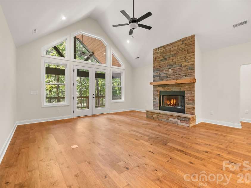 32 Ossarooga Court, Brevard, NC 28712.  MLS# CAR4423106, YatesRealty ID 50509. Floor to ceiling rock fireplace adds warmth