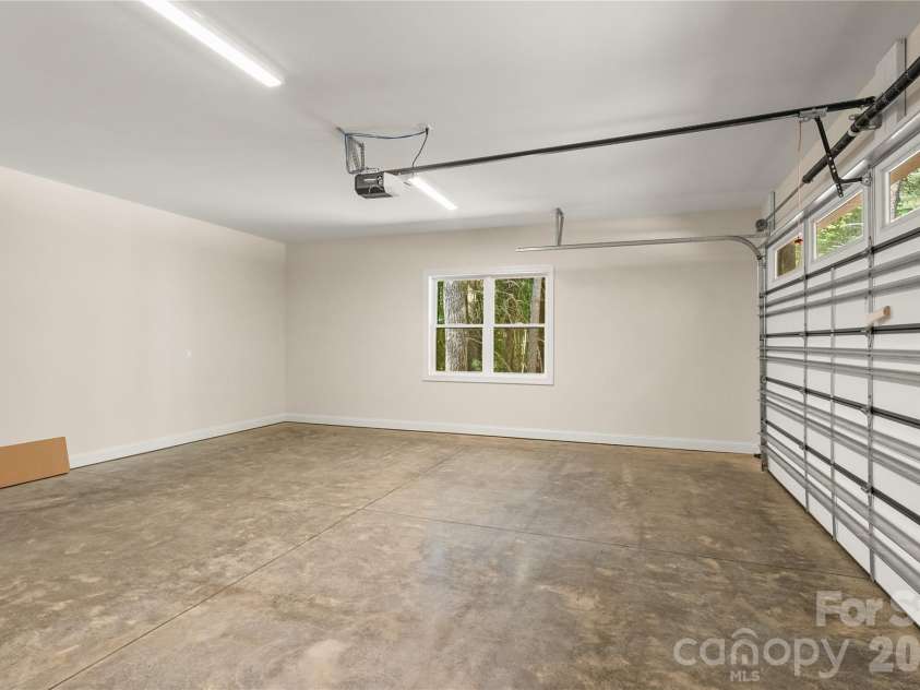 32 Ossarooga Court, Brevard, NC 28712.  MLS# CAR4423106, YatesRealty ID 50509. Level driveway into a 2-car garage..