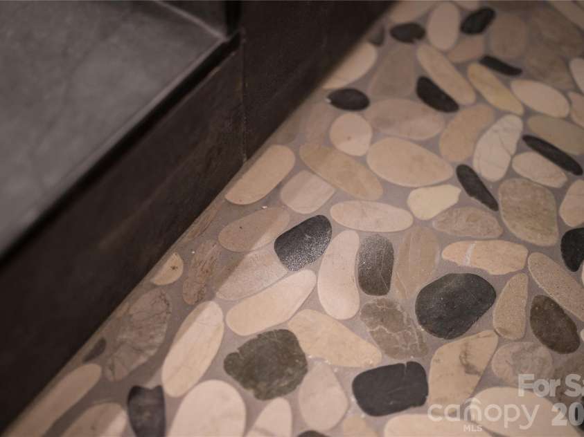 32 Ossarooga Court, Brevard, NC 28712.  MLS# CAR4423106, YatesRealty ID 50509. Pebble tile shower floor
