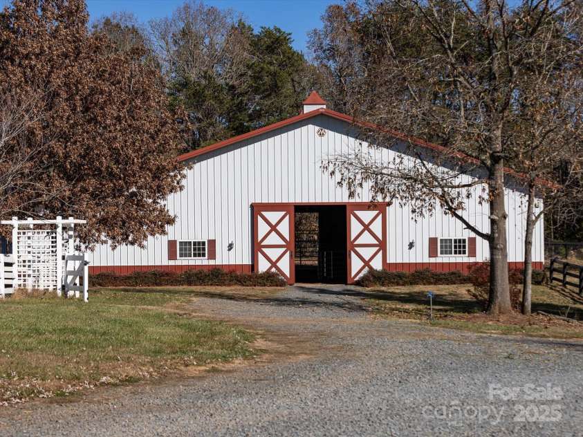 172 Tuckertown Road, New London, NC 28127.  MLS# CAR4215273, YatesRealty ID 5053. Indoor Arena with Adjacent Stalls