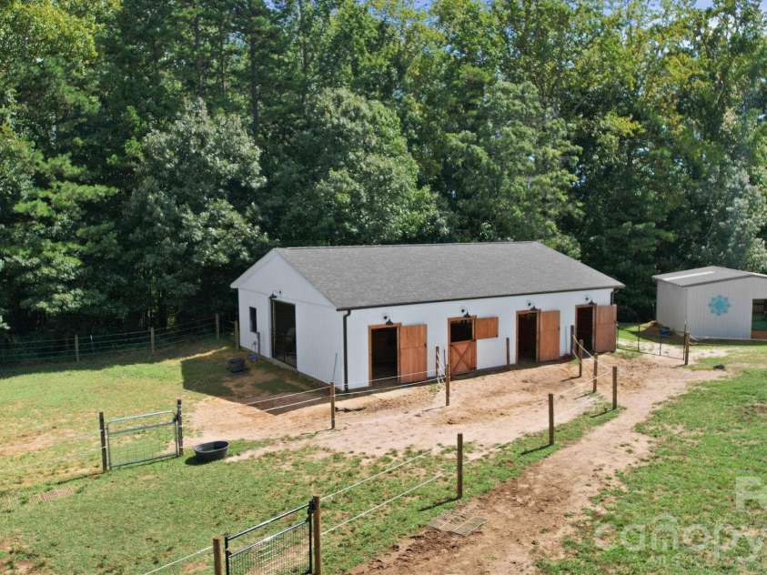 4035 Daugherty Road, China Grove, NC 28023.  MLS# CAR4417905, YatesRealty ID 50534. Stalls open up to separate pastures