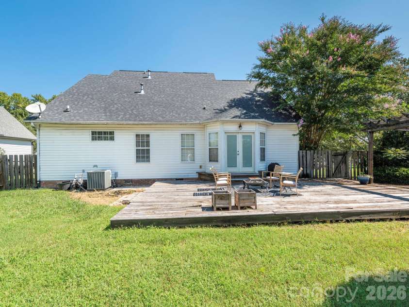 3401 Continental Drive, Monroe, NC 28110.  MLS# CAR4420024, YatesRealty ID 50540. Backyard deck in the fenced yard