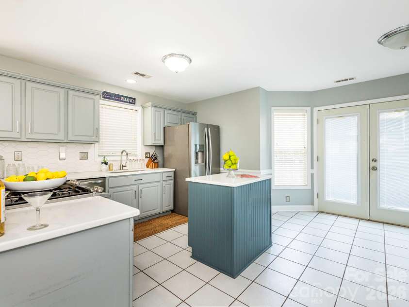 3401 Continental Drive, Monroe, NC 28110.  MLS# CAR4420024, YatesRealty ID 50540. Kitchen with coastal colors and gorgeous white counters, tile backsplash, stainless steel appliances and a gas stove