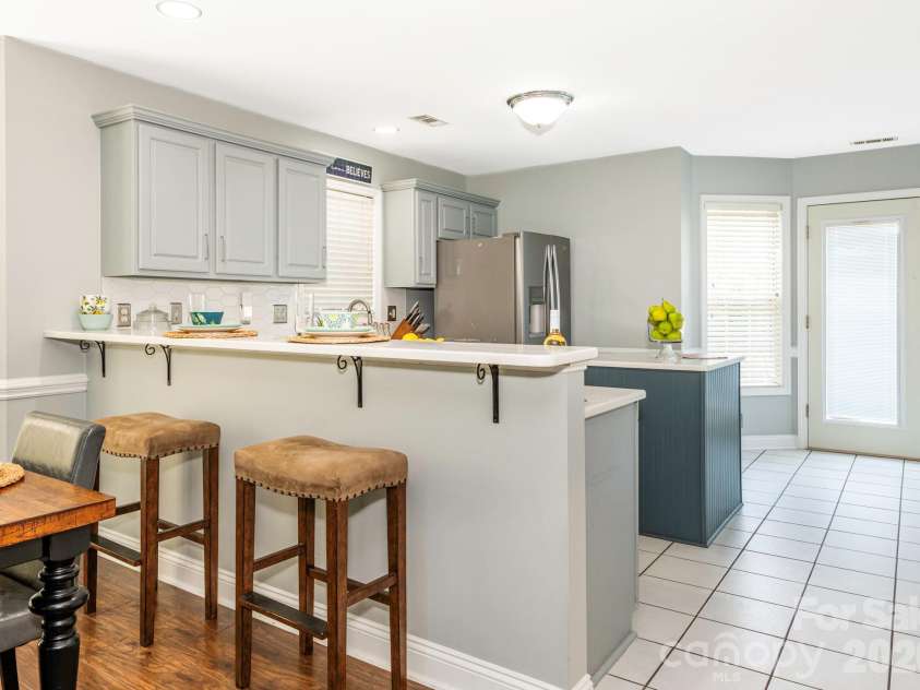 3401 Continental Drive, Monroe, NC 28110.  MLS# CAR4420024, YatesRealty ID 50540. Kitchen with island and direct access to the back deck and yard