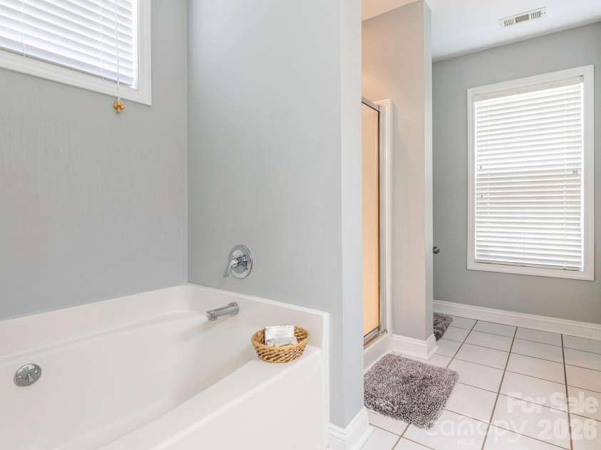 3401 Continental Drive, Monroe, NC 28110.  MLS# CAR4420024, YatesRealty ID 50540. Soaking tub and separate shower in the primary bathroom