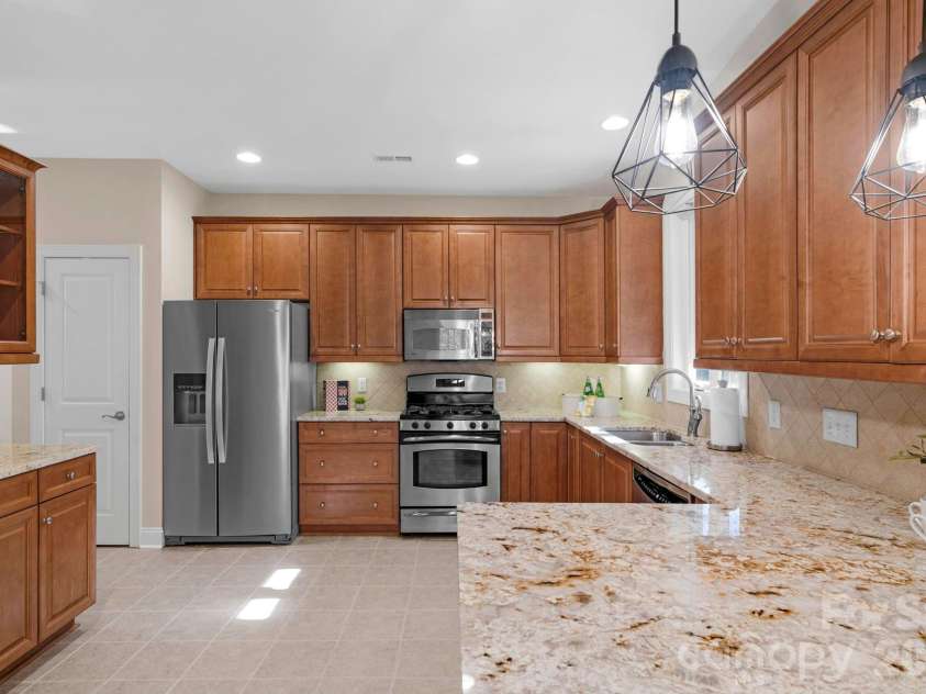 3038 Bellasera Way, Matthews, NC 28105.  MLS# CAR4319866, YatesRealty ID 50545. Upgraded cabinetry with pull-outs.