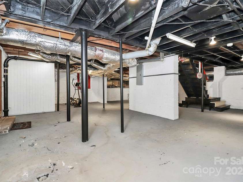 106 Patrick Street, Gastonia, NC 28054.  MLS# CAR4211369, YatesRealty ID 5055. Unfinished basement with door leading to tandem 2 car garage.