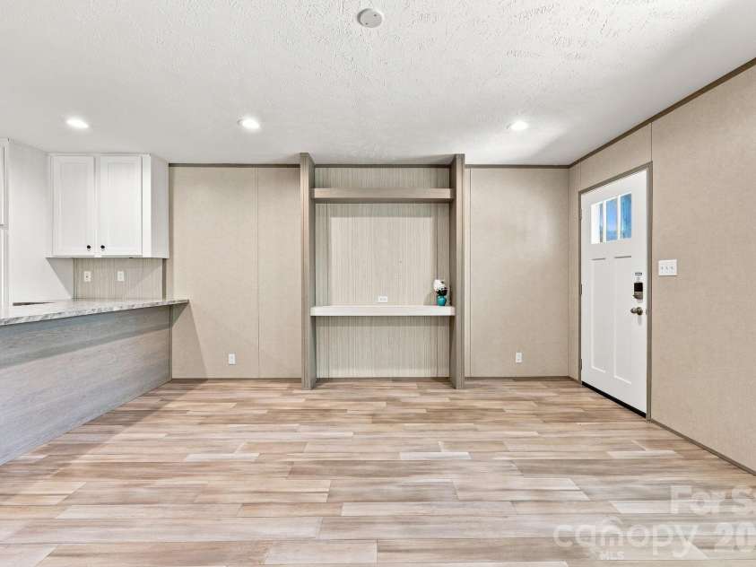 146 & 148 Bradshaw Circle, Candler, NC 28715.  MLS# CAR4424703, YatesRealty ID 50552. Built-ins in Living Room, open to Kitchen