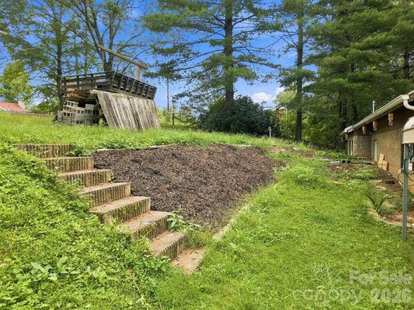 146 & 148 Bradshaw Circle, Candler, NC 28715.  MLS# CAR4424703, YatesRealty ID 50552. Stairs from Upper to Lower Home