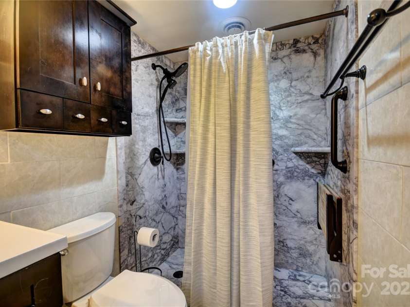 119 Pleasant Hill Circle, Waynesville, NC 28786.  MLS# CAR4325217, YatesRealty ID 506. Easy-Access shower in the lower level primary bathroom