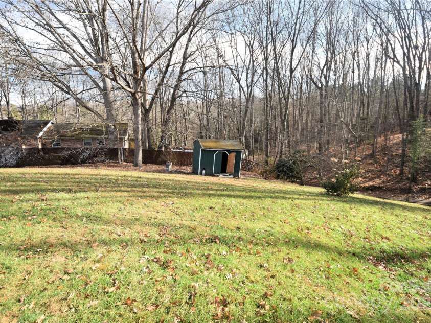 119 Pleasant Hill Circle, Waynesville, NC 28786.  MLS# CAR4325217, YatesRealty ID 506. Large backyard with a storage building