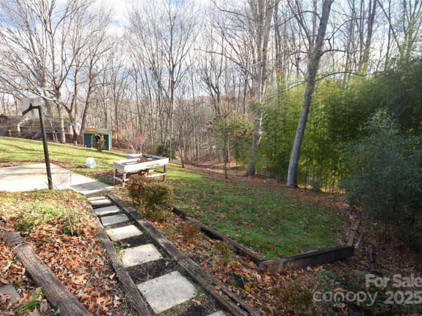 119 Pleasant Hill Circle, Waynesville, NC 28786.  MLS# CAR4325217, YatesRealty ID 506. Large side yard with path from the garage and driveway
