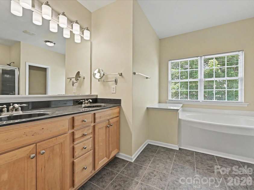 152 Lighthouse Road, Mount Holly, NC 28120.  MLS# CAR4389508, YatesRealty ID 5060. Master bathroom with dual vanity, new lighting