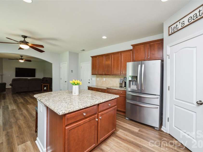 4901 Annelise Drive, Harrisburg, NC 28075.  MLS# CAR4424129, YatesRealty ID 50605. Kitchen and Den