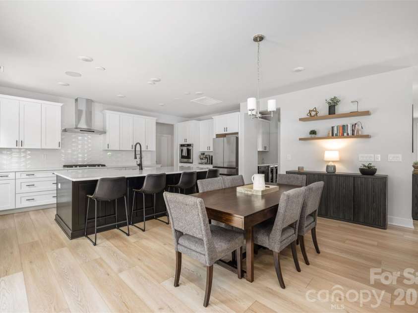 4320 Tournette Drive, Indian Land, SC 29707.  MLS# CAR4420198, YatesRealty ID 50610. Kitchen with oversized black island, quartz counters, tile backsplash to the ceiling, and KitchenAid appliances