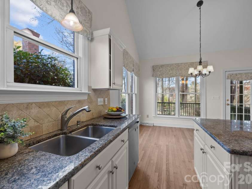 100 Martin Street, Davidson, NC 28036.  MLS# CAR4341669, YatesRealty ID 5062. The thoughtful design element and layout with the sink positioned directly beneath a window makes the chore feel less like work and more connected to the outdoors.
