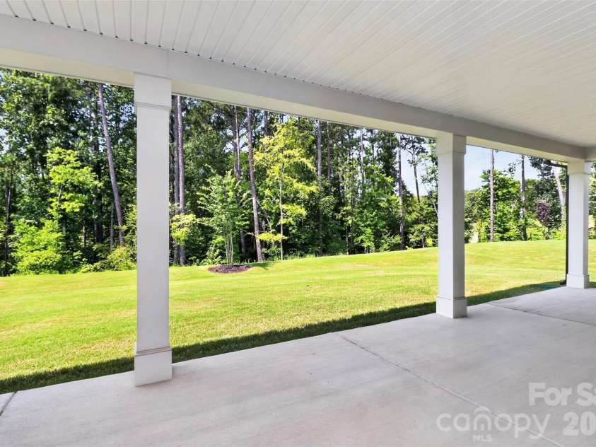 235 Supernova Drive, York, SC 29745.  MLS# CAR4417452, YatesRealty ID 50640. Rear covered patio faceing tree lined backyard