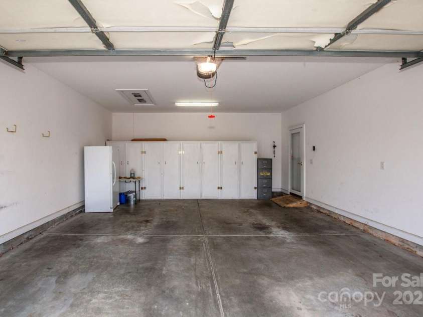 8320 Highland Glen Drive, Charlotte, NC 28269.  MLS# CAR4324740, YatesRealty ID 50643. 2 Car Garage - lots of storage cabinet - Freezer